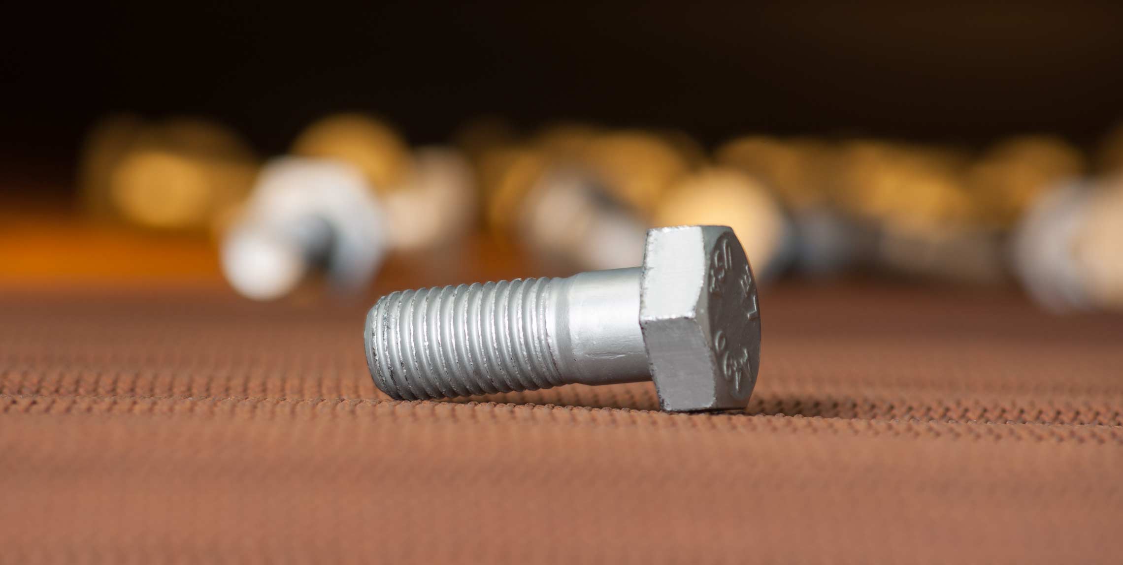 A freshly coated bolt is carried out of the GEOMET dip-spin coating oven at 600 degrees fahrenheit.